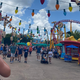 Holiday lights and giant tinker toys are the decorations in Toy Story Land. A roller coaster can be seen in the background on the right.
